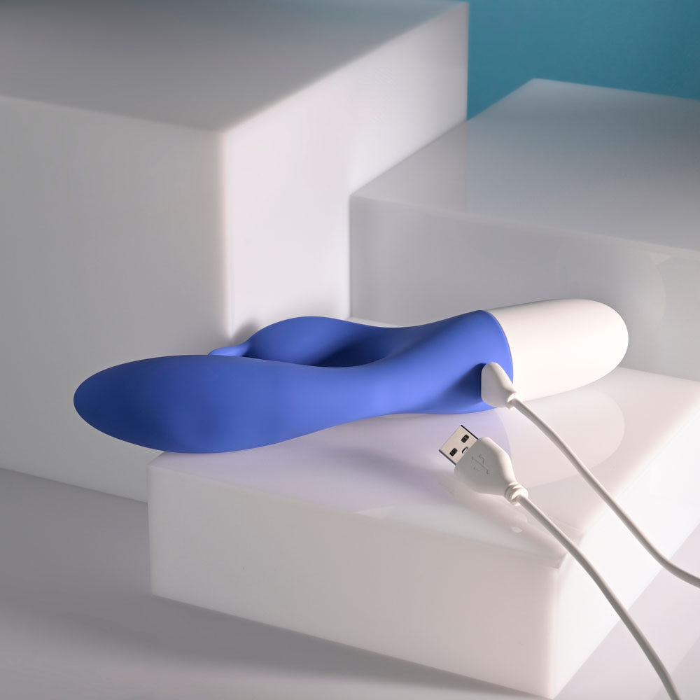 Evolved FUNNY BUNNY - 20 cm USB Rechargeable Rabbit Vibrator on white surfaces with USB connection.