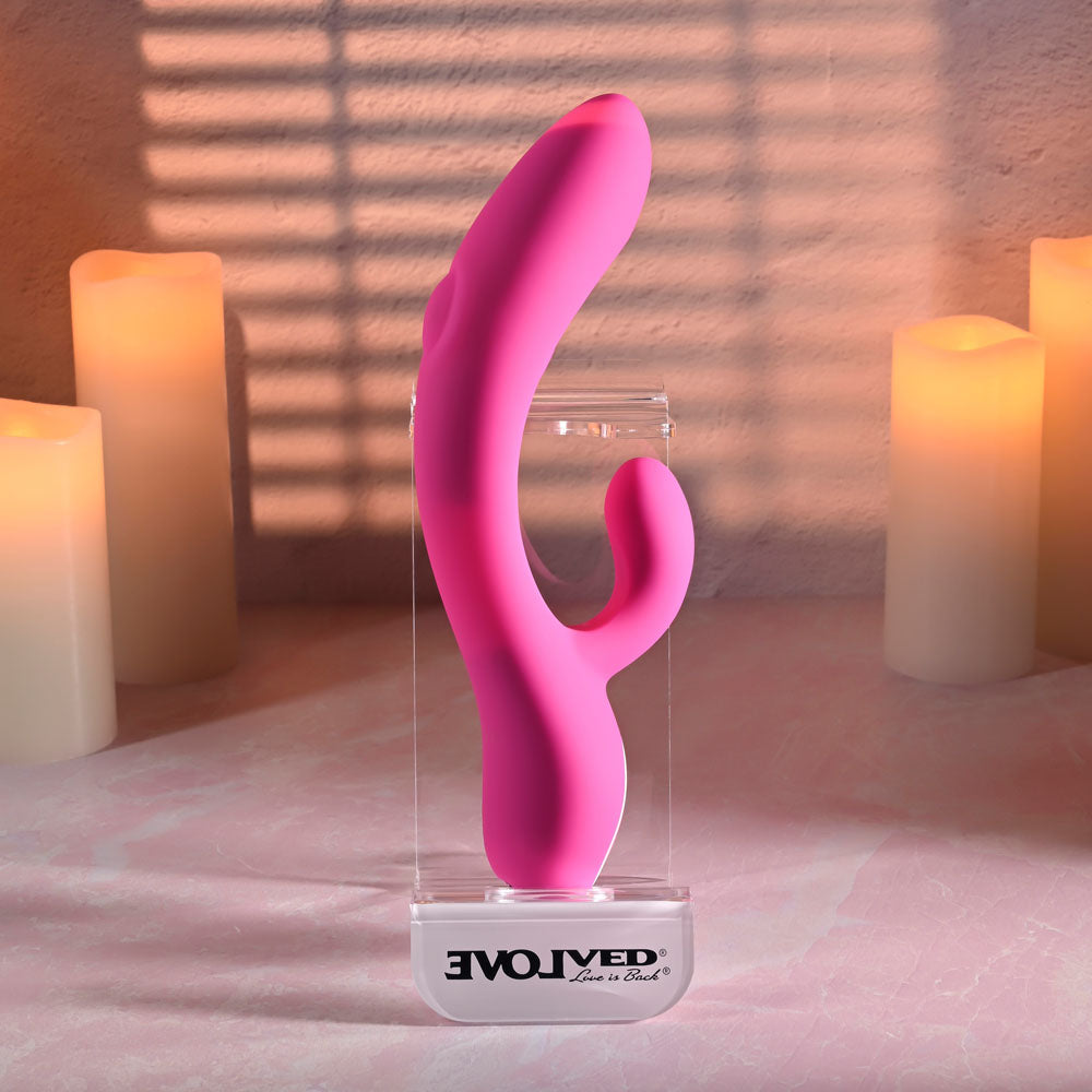 Evolved G-TAPPER -  USB Rechargeable Rabbit Vibrator displayed with candles, highlighting its curved design and dual stimulating functions.