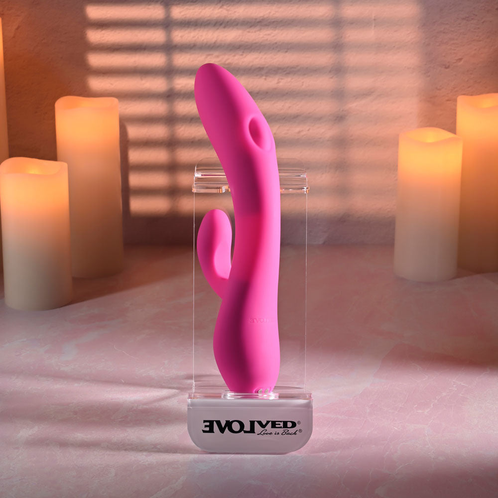 Evolved G-TAPPER - USB Rechargeable Rabbit Vibrator displayed among candles, showcasing its design and intimate appeal.