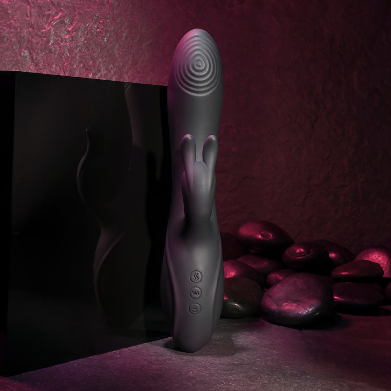 Evolved RABBIT HOLE - 21.2 cm USB Rechargeable Rabbit Vibrator displayed with dark stones and ambient lighting.