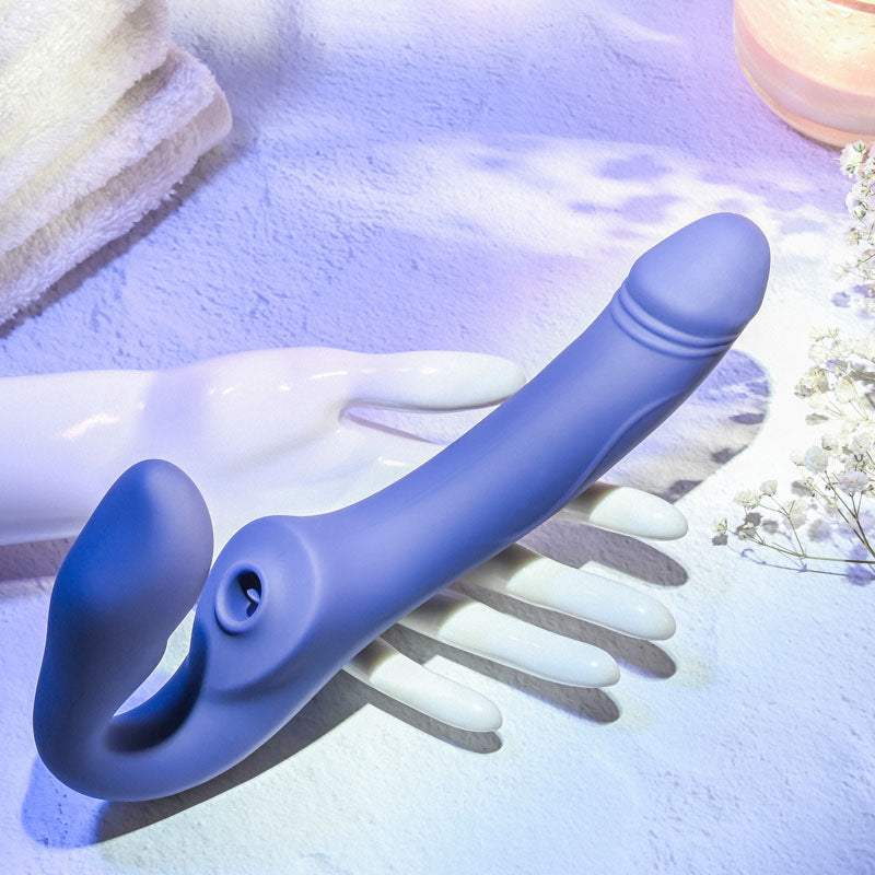 Evolved 2 BECOME 1 -  23.5 cm USB Rechargeable Strapless Strap-On with Remote on a hand with soft background.