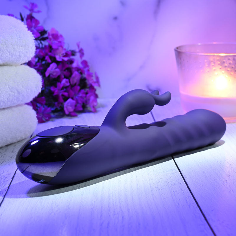 Evolved RASCALLY RABBIT - 22.9 cm USB Rechargeable Rabbit Vibrator displayed with towels and candles in a relaxing setting.