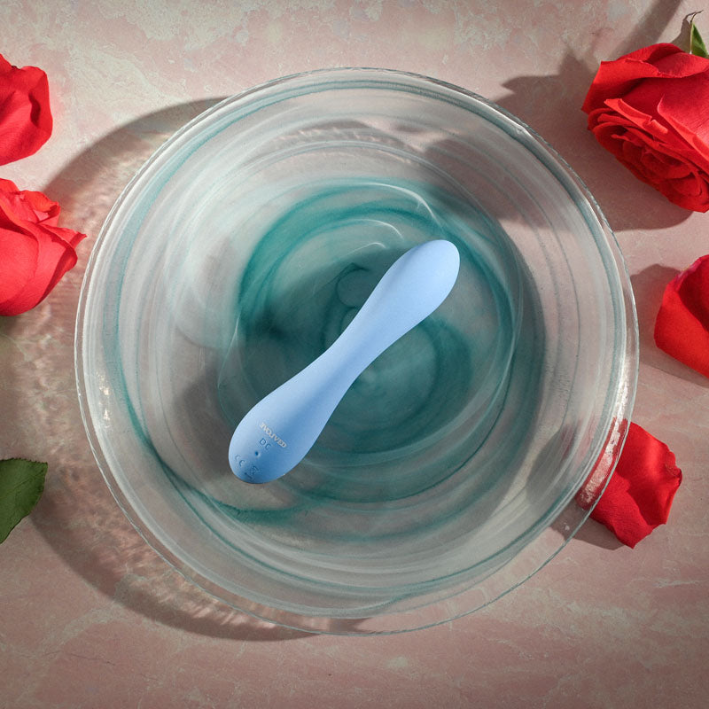 Evolved  CRUSH - 12 cm USB Rechargeable Mini Vibrator displayed in a bowl of water surrounded by red roses.