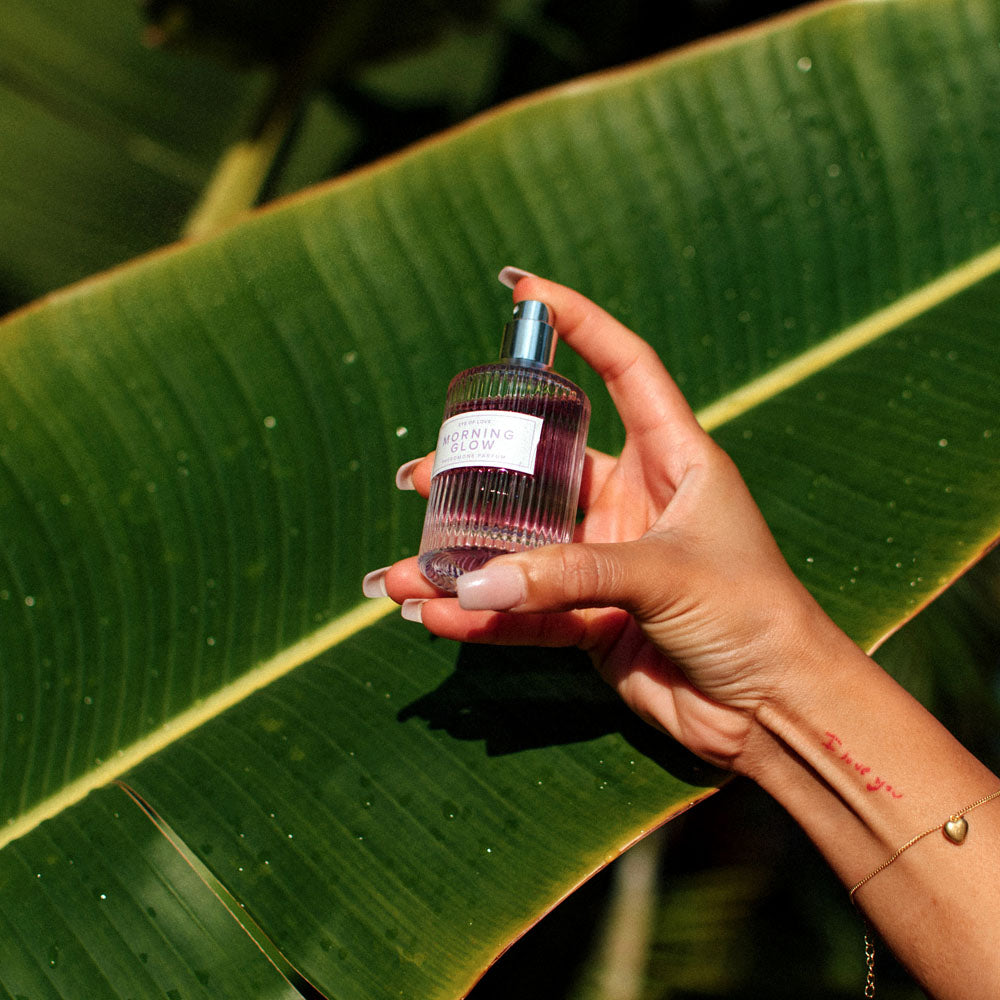 Eye Of Love Morning Glow Pheromone Perfume - 50 ml - Energising Pheromone Perfume for Women to attract Men - 50 ml Spray on a vibrant leaf.