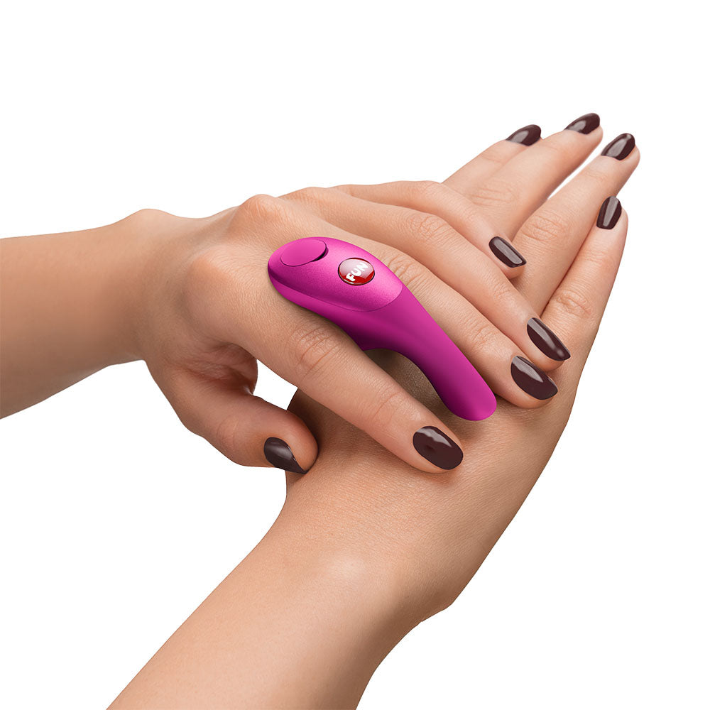 Fun Factory BE-ONE Magenta - Magenta USB-C Rechargeable Finger Stimulator on a hand demonstrating its ergonomic design.