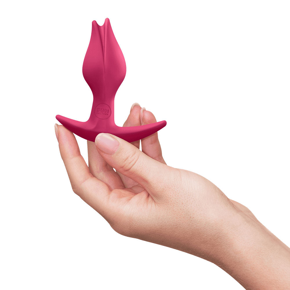 Fun Factory BOOTIE FEM Raspberry - Raspberry  8.5 cm Butt Plug held in hand, showcasing its comfortable design.