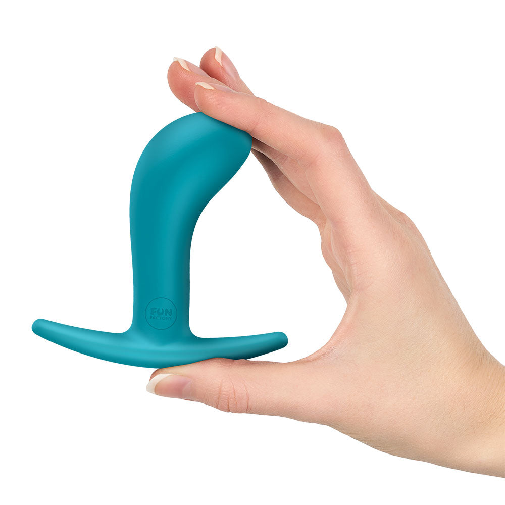 Fun Factory BOOTIE M Aquamarine - Aquamarine 9.4 cm Medium Butt Plug held in hand, perfect for comfortable stimulation.