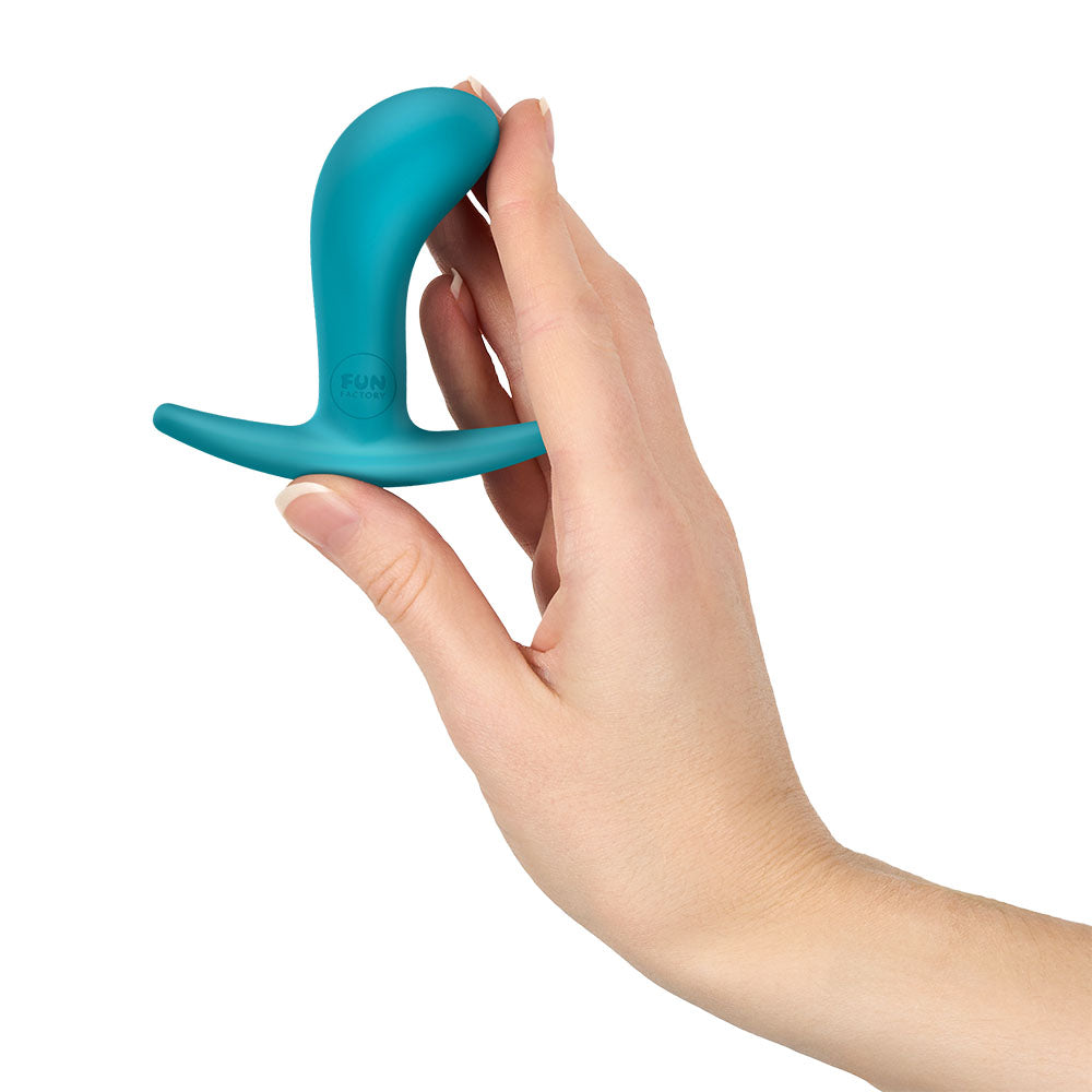 Fun Factory BOOTIE S Aquamarine - Aquamarine 7.9 cm Small Butt Plug held in hand, showcasing its compact design.