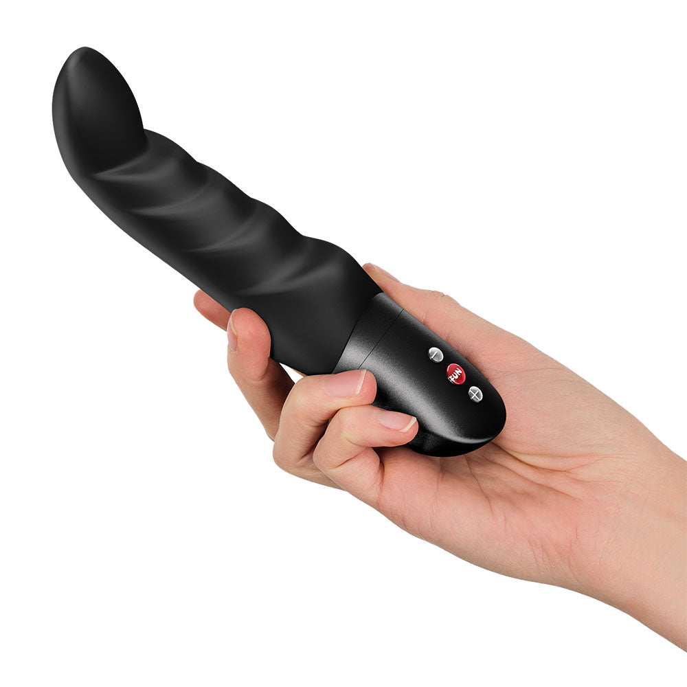 Fun Factory ABBY G - 18.8 cm Vibrator held in a hand, showcasing its curved tip and ribbed texture for G-spot stimulation.