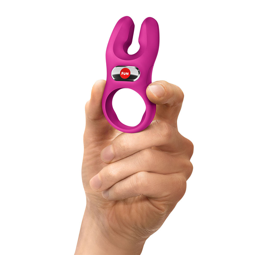 Fun Factory NOS PRO Magenta - Magenta USB-C Rechargeable Vibrating Cock Ring held in hand for intimacy.