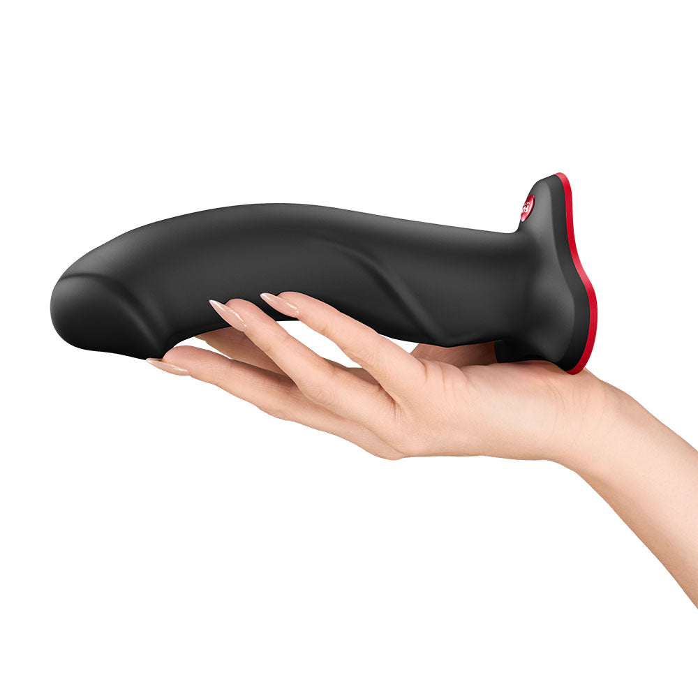 Fun Factory THE BOSS STUB - 17.8 cm Dildo held in hand, showcasing its sleek design and satisfying size.