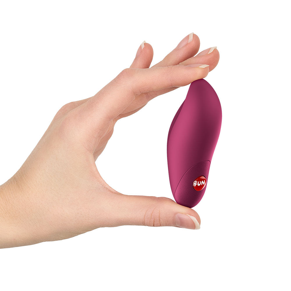Fun Factory CHARME Wine  - Wine  USB-C Rechargeable Stimulator held in hand, showcasing its ergonomic design and vibrant color.