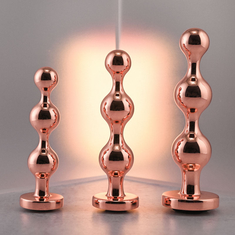 Gender X GOLD DIGGER SET -  Metallic Butt Plugs - Set of 3 Sizes featuring sleek metal designs.