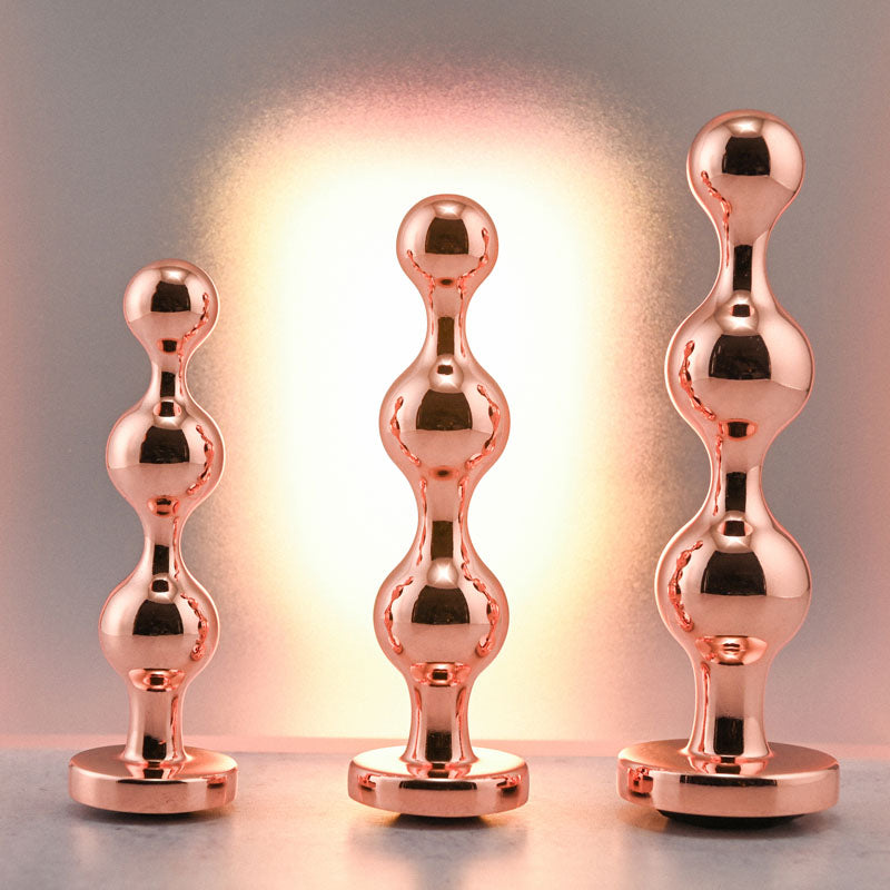 Gender X GOLD DIGGER SET -  Metallic Butt Plugs - Set of 3 Sizes showcasing sleek metal design and bulbous shapes.