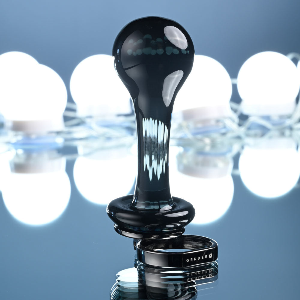 Gender X BLOW POP -  12.8 cm Glass Plug with Ring Pull on reflective surface with blurred lights in background.