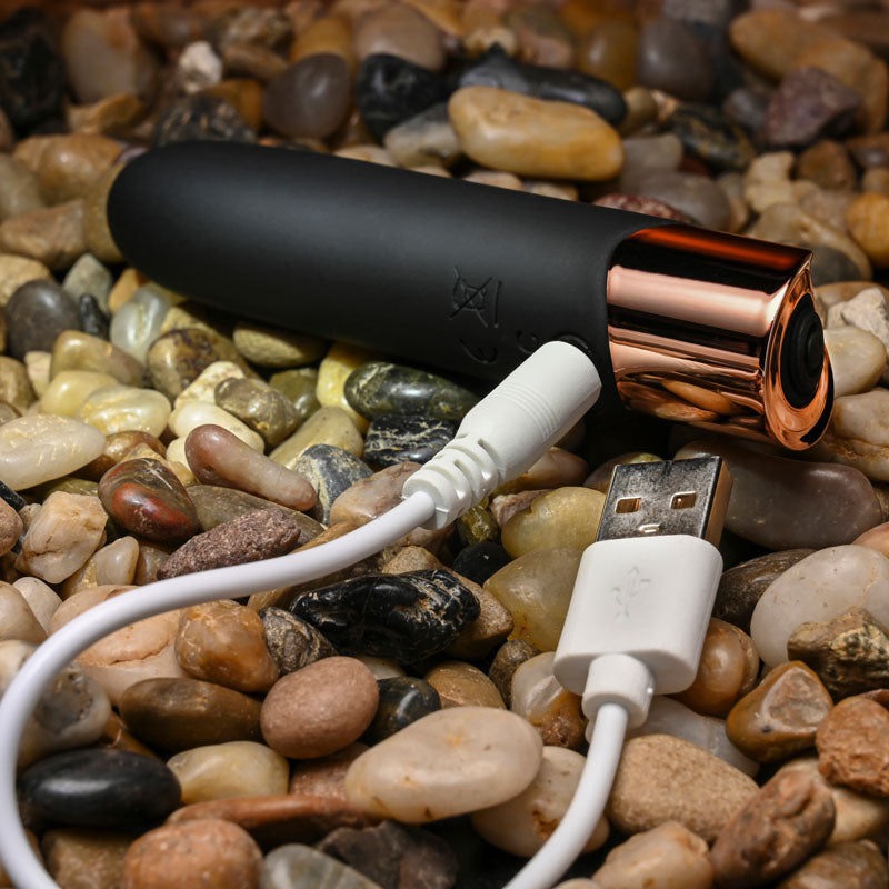 Gender X THE GOLD STANDARD - /Rose Gold 10 cm USB Rechargeable Bullet on pebbles with USB cable.