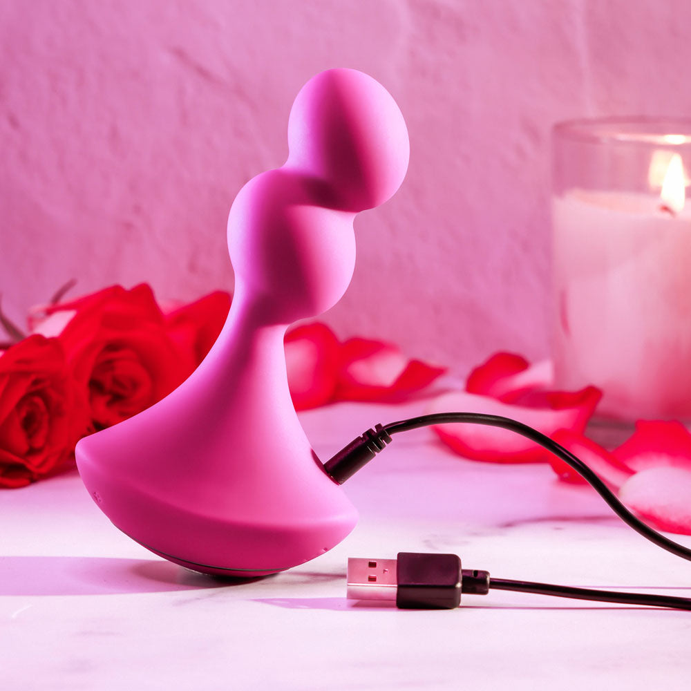 Gender X BALL GAME -  13.5 cm USB Rechargeable Vibrating Butt Plug charging next to roses and a candle.