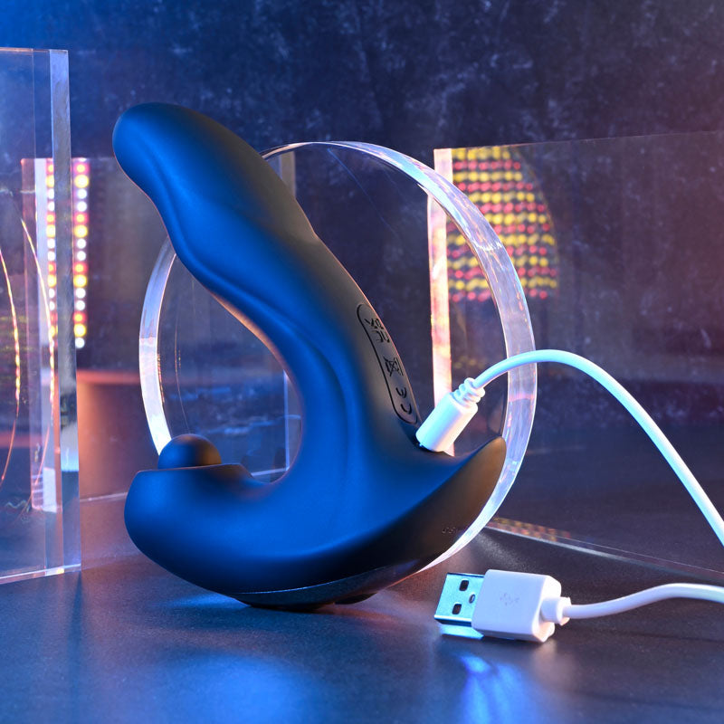 Gender X MAD TAPPER - USB Rechargeable Double Tapping Vibrating Massager charging on a modern display with vibrant lighting.
