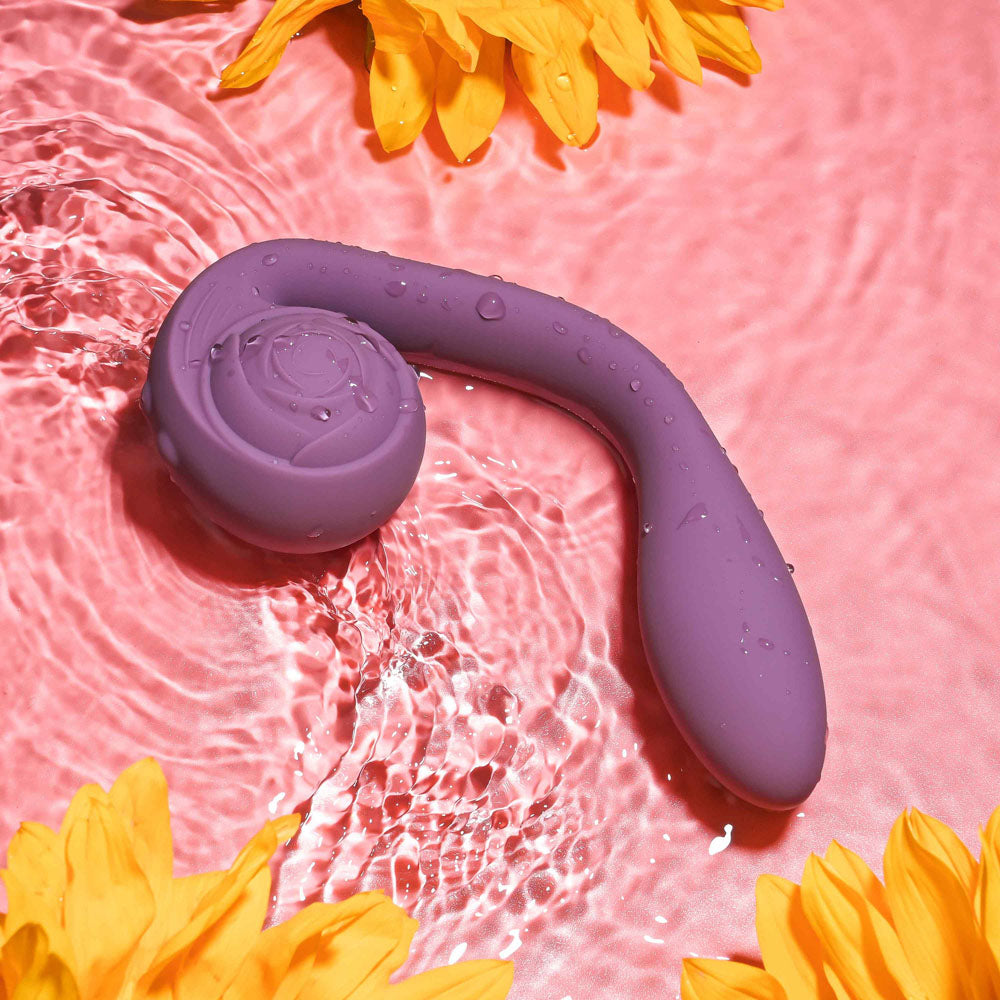 Gender X POSEABLE YOU - USB Rechargeable Poseable Vibrator floating in water with sunflowers