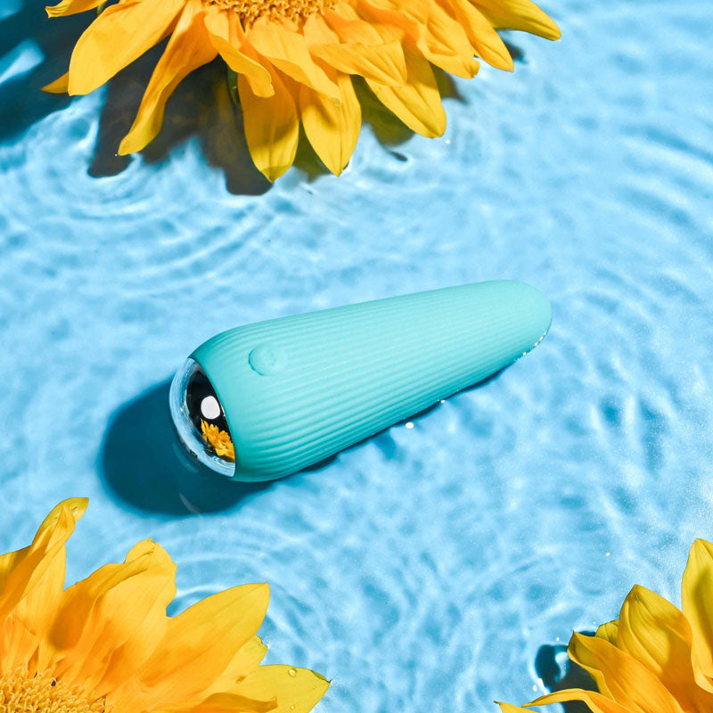 Gender X O-CONE - 10.8 cm (4.25'') USB Rechargeable Bullet resting in a pool with sunflowers