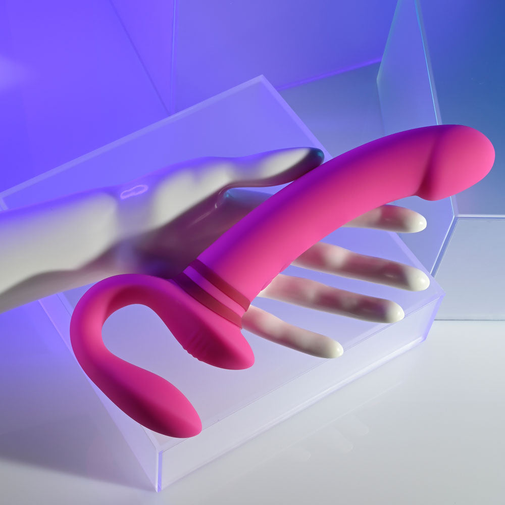 Gender X SHARING IS CARING - 21.9 cm USB Rechargeable Strapless Strap-On on display with a hand for scale.