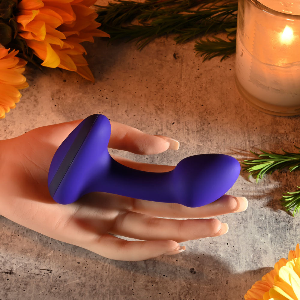 Gender X ANYBODYS PLUG - 11.4 cm USB Rechargeable Vibrating Butt Plug resting in a hand with a vibrant background.