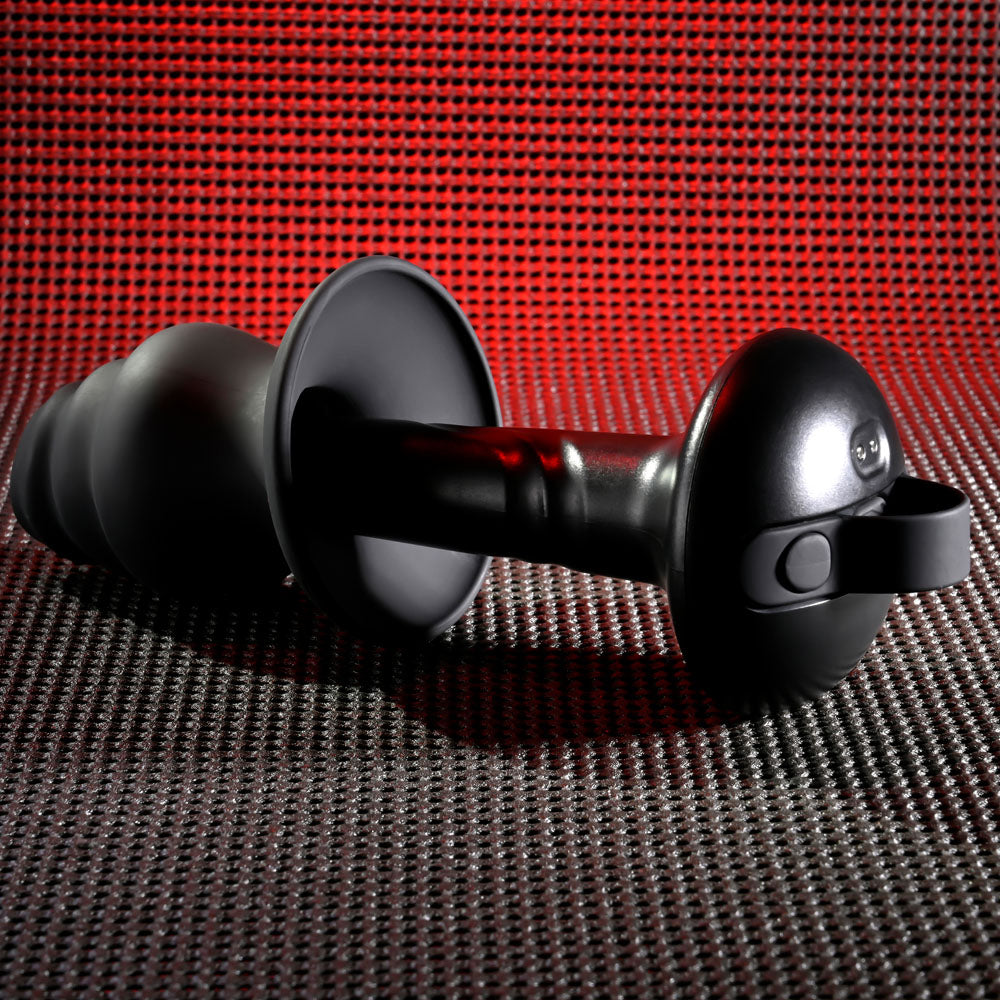 Gender X ECHO - 15.3 cm USB Rechargeable Butt Plug on textured surface with red lighting