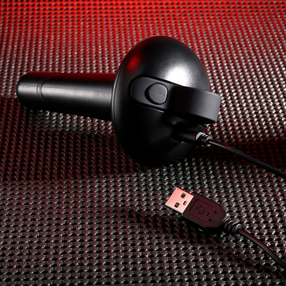 Gender X ECHO - 15.3 cm USB Rechargeable Butt Plug with USB cable on textured surface.