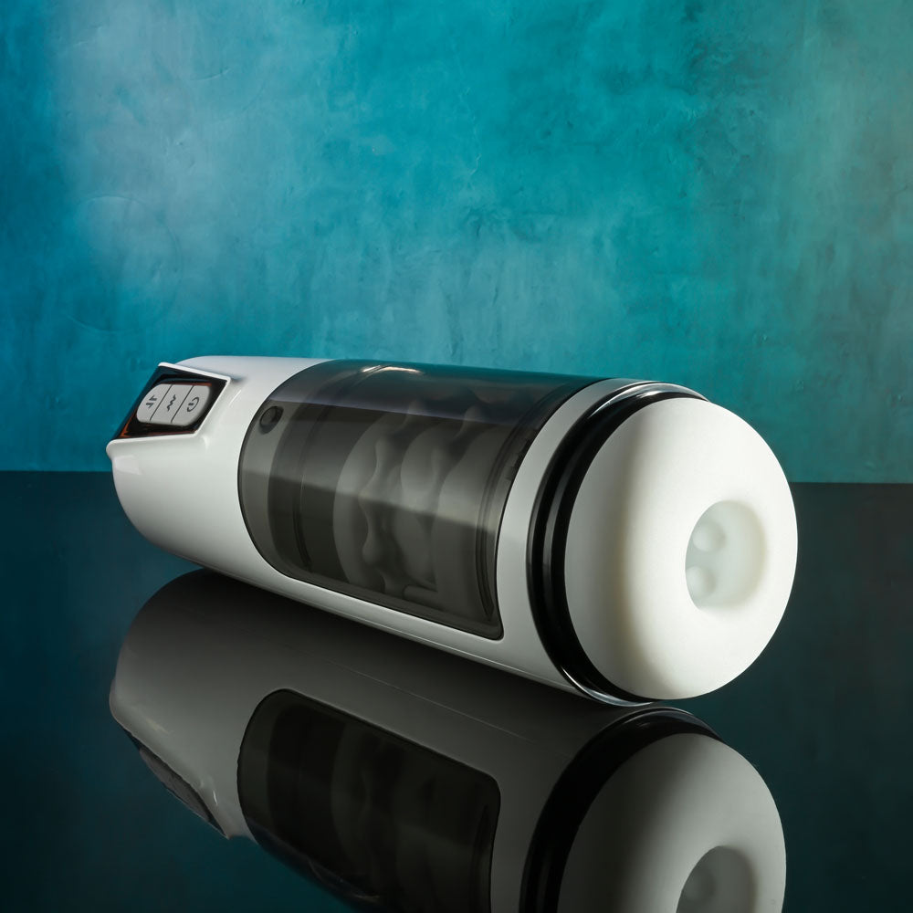 Gender X GET YOUR STROKE ON - USB Rechargeable Thrusting & Vibrating Auto Masturbator on a reflective surface.