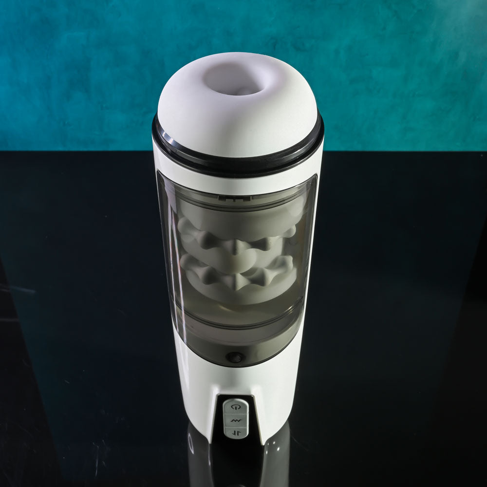 Gender X GET YOUR STROKE ON - USB Rechargeable Thrusting & Vibrating Auto Masturbator on a sleek black surface.