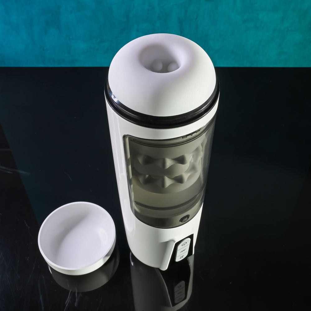 Gender X GET YOUR STROKE ON - USB Rechargeable Thrusting & Vibrating Auto Masturbator on a sleek black surface.