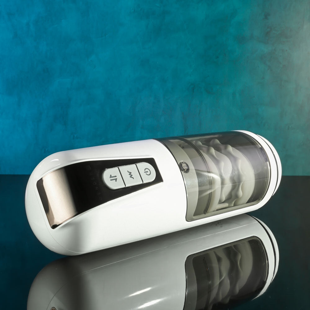 Gender X GET YOUR STROKE ON - USB Rechargeable Thrusting & Vibrating Auto Masturbator on reflective surface.