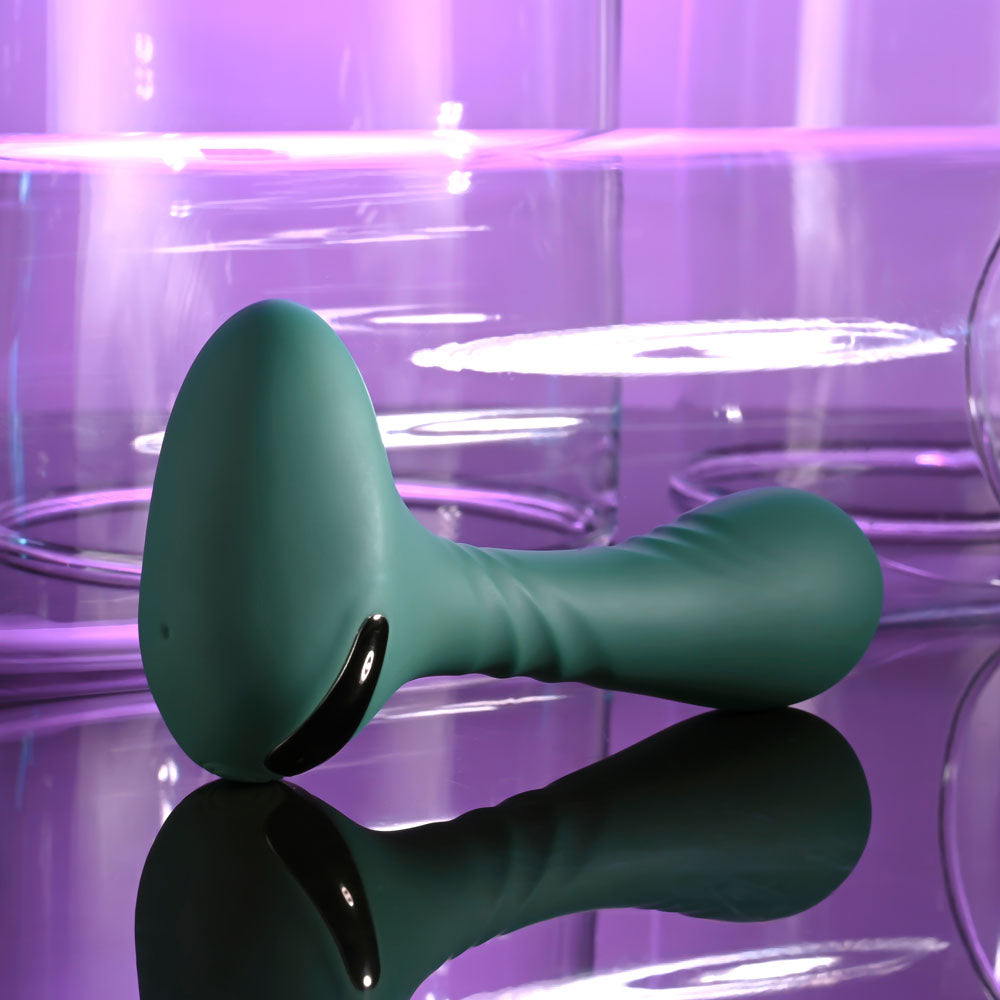 Gender X GOES ANYWHERE -  12.4 cm USB Rechargeable Vibrator on a reflective surface with purple background.
