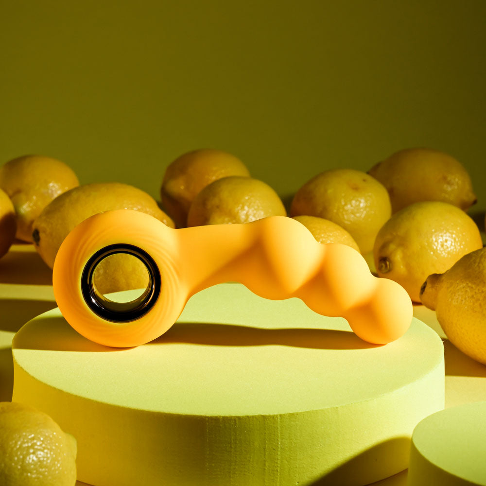 Gender X BUMBLE - 14.9 cm USB Rechargeable Butt Plug on a yellow background with lemons.
