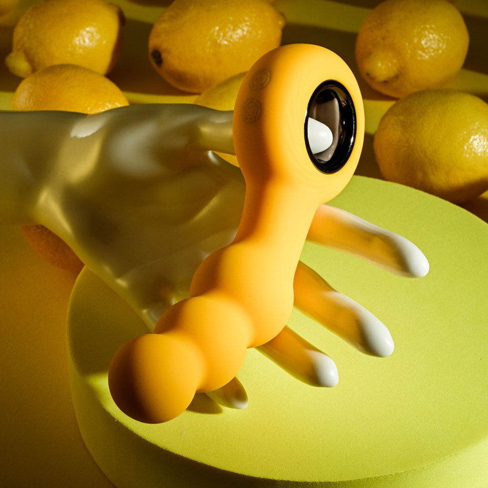 Gender X BUMBLE -  14.9 cm USB Rechargeable Butt Plug next to lemons, highlighting its vibrant design and functionality.