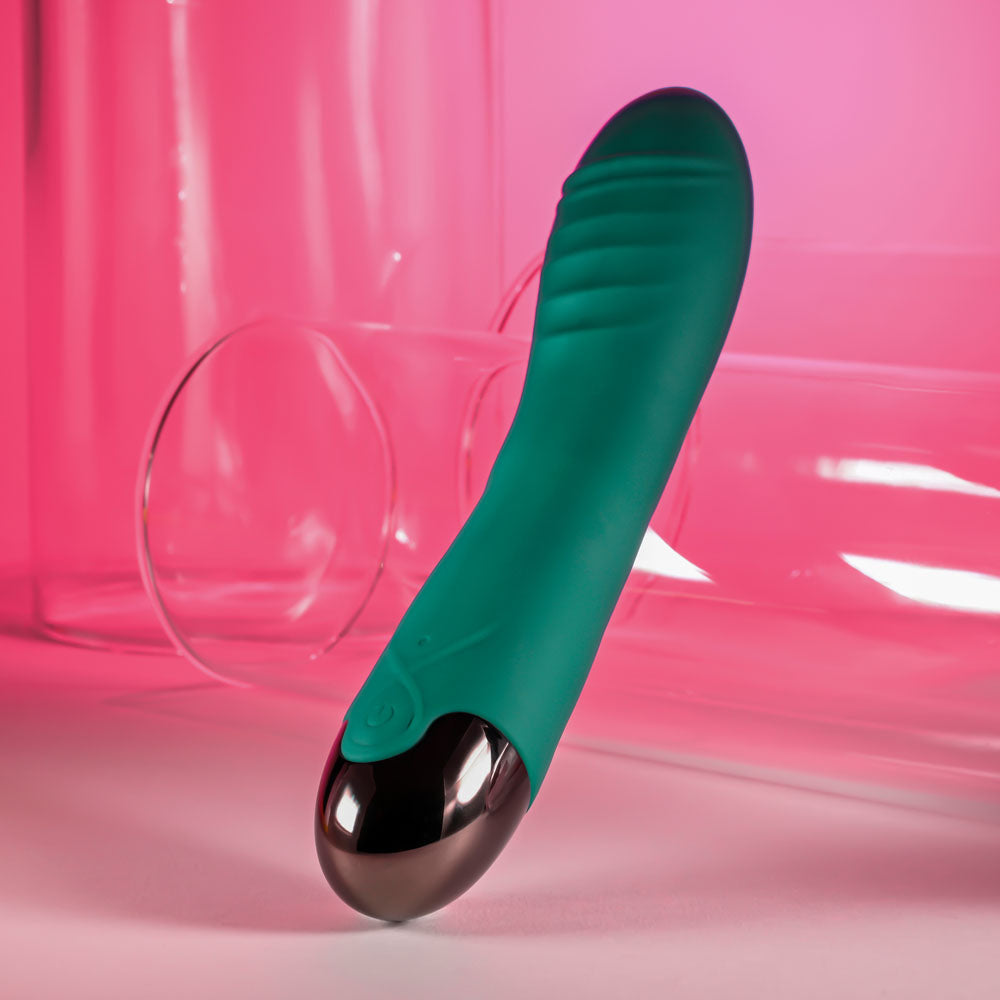 Gender X PIROUETTE -  20.6 cm USB Rechargeable Vibrator showcased against a pink background.