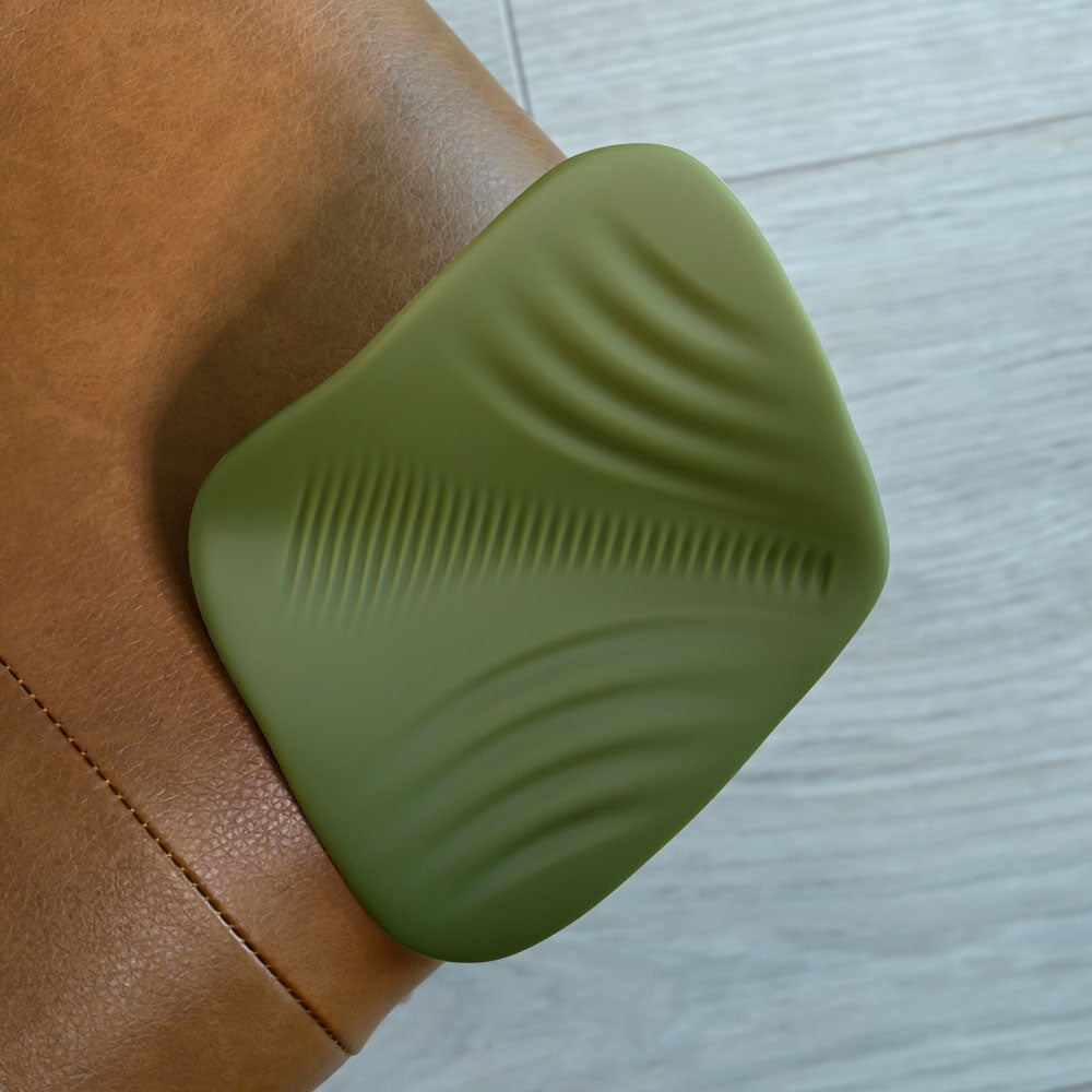 Gender X PLEASURE PAD - USB Rechargeable Grinding Pad on brown leather surface with textured design for intimate pleasure.