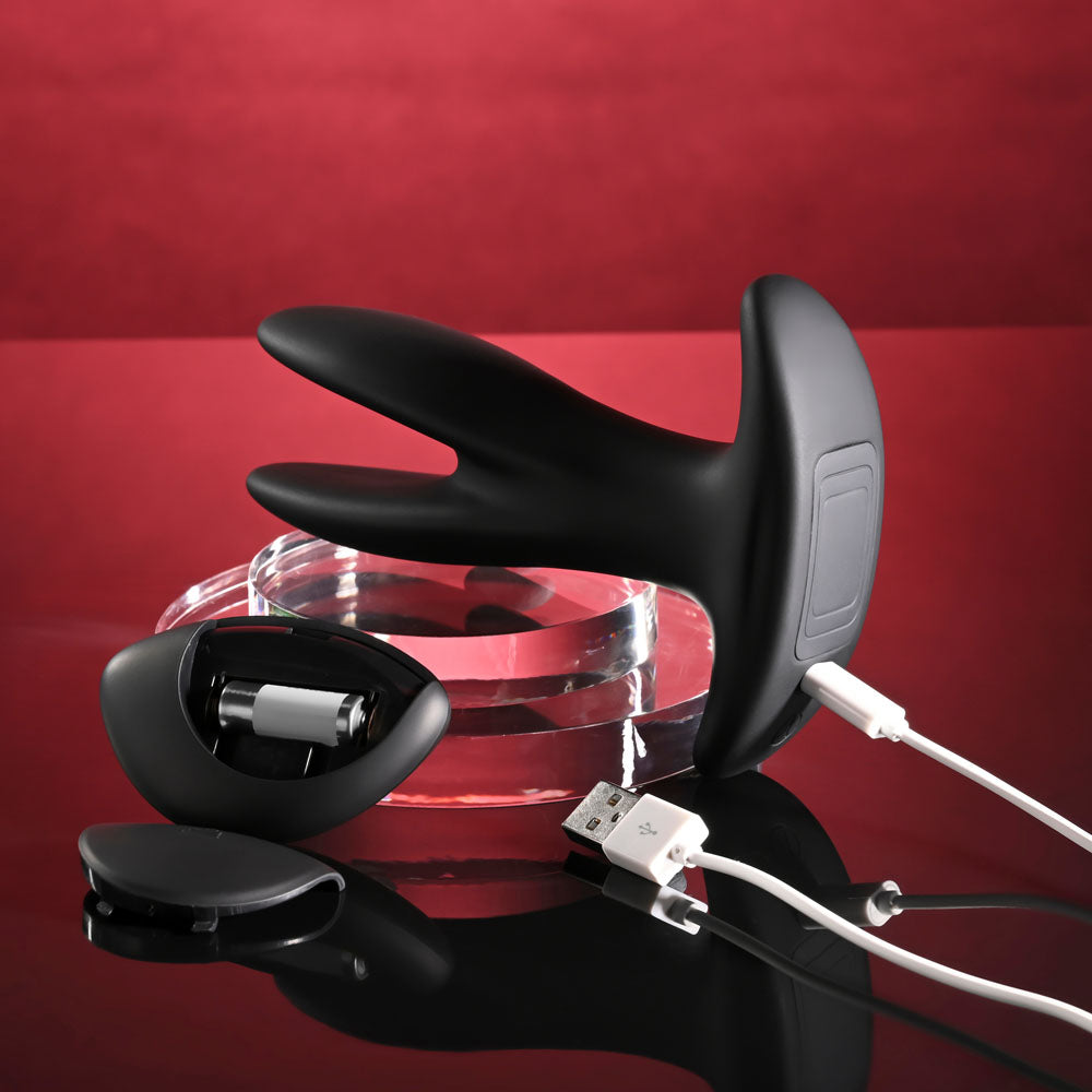Gender X SPREAD THE LOVE -  USB Rechargeable Stretching Anal Plug with Wireless Remote on a reflective surface.