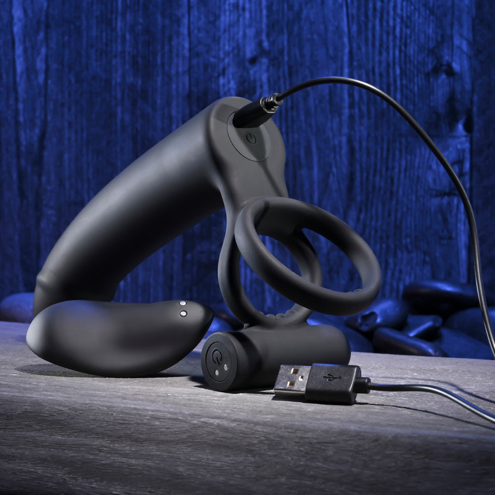 Gender X FULL SWING -  USB Rechargeable Vibrating Cock Ring with Double Penetrator Dildo on a wooden surface.