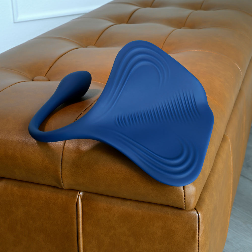 Gender X DAILY GRIND -  USB Rechargeable Grinding Pad with Anal Plug on a leather couch.