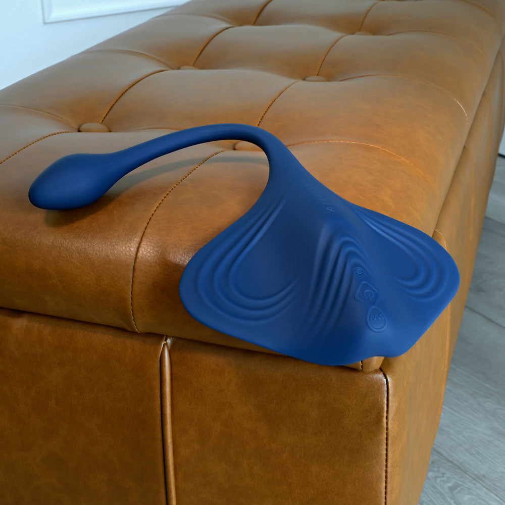 Gender X DAILY GRIND -  USB Rechargeable Grinding Pad with Anal Plug on a leather ottoman.