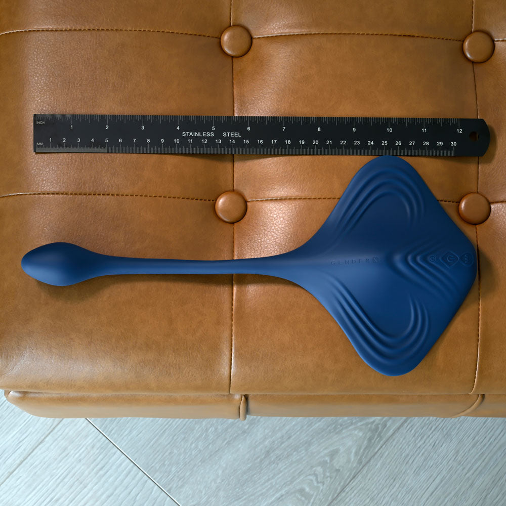 Gender X DAILY GRIND -  USB Rechargeable Grinding Pad with Anal Plug on a leather surface with a ruler for size reference.