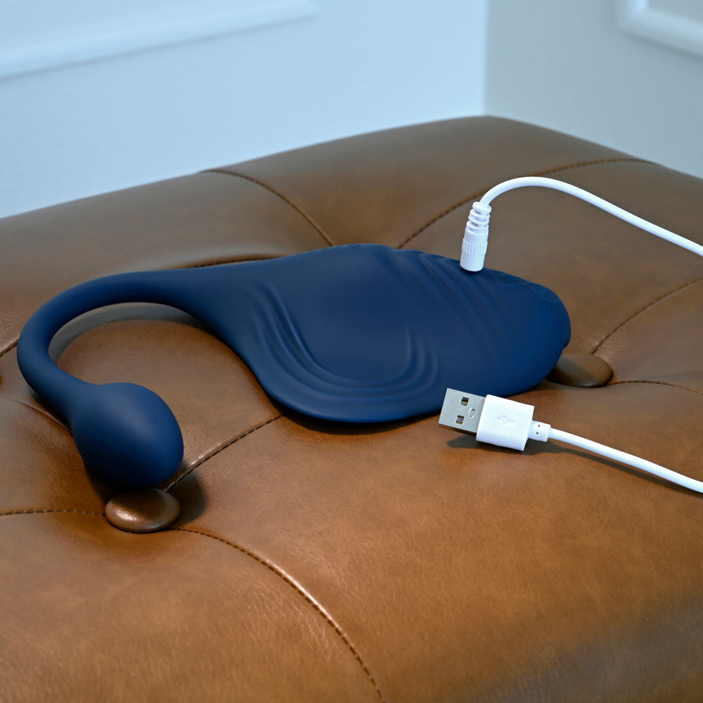 Gender X DAILY GRIND -  USB Rechargeable Grinding Pad with Anal Plug on a leather surface with charging cable.
