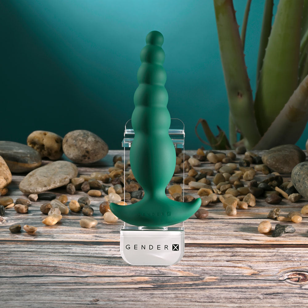 Gender X THE RATTLER - 17 cm USB rechargeable vibrating anal plug on a stone surface.