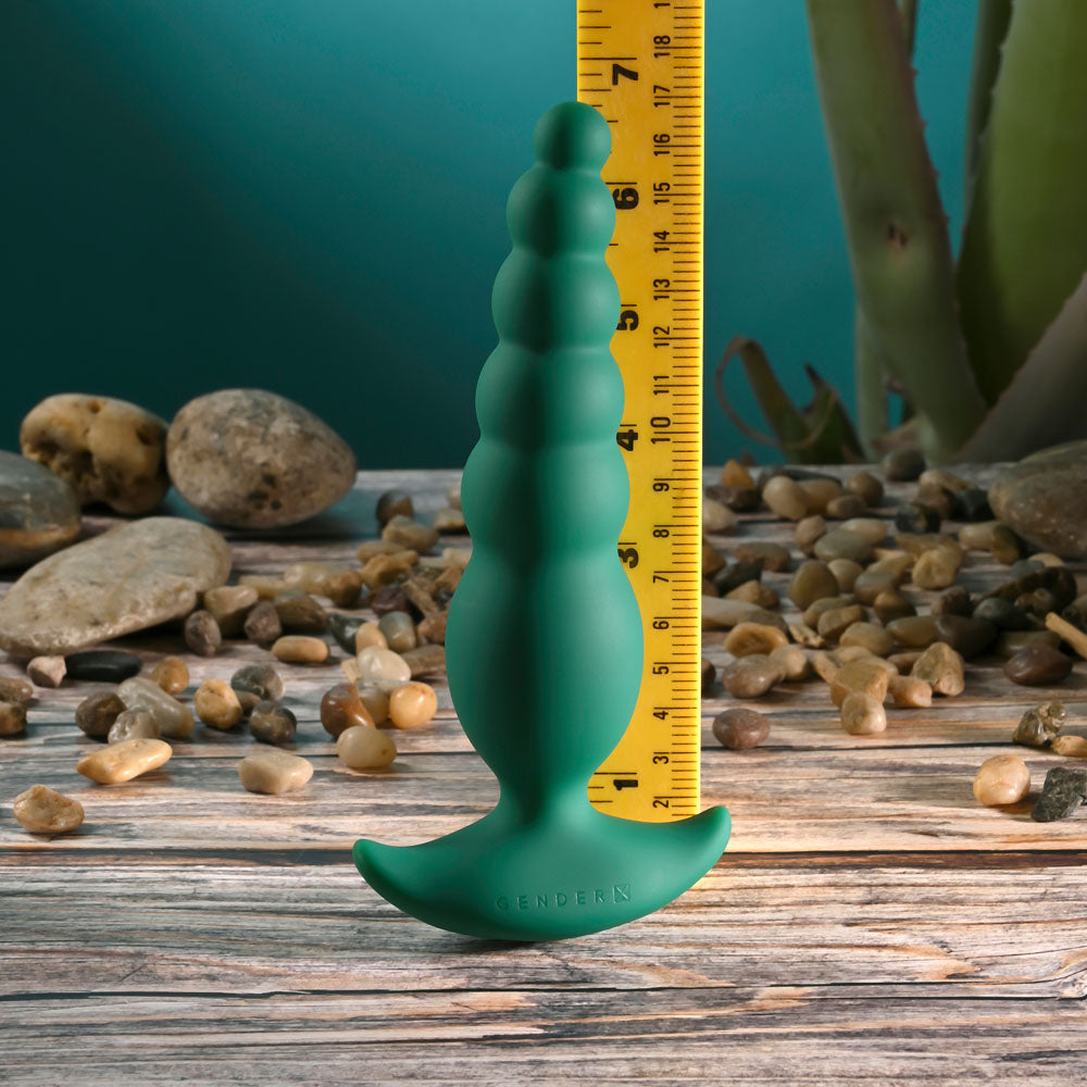 Gender X THE RATTLER -  17 cm USB Rechargeable Vibrating and Twirling Anal Plug next to a ruler for size reference.