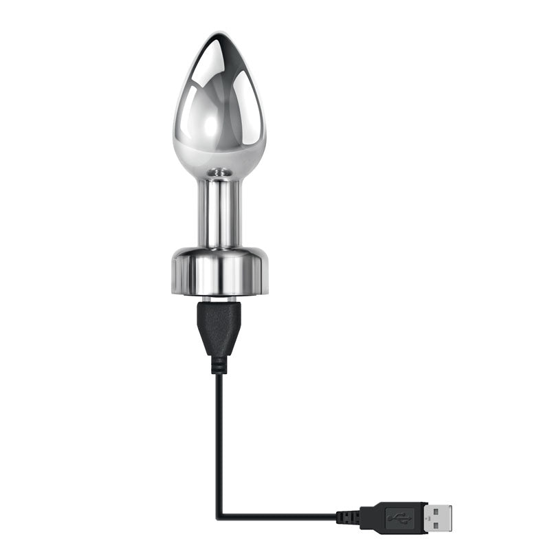 Gender X ROCKIN' METAL PLUG - Metallic 9.3 cm USB Rechargeable Butt Plug connected to USB charger.