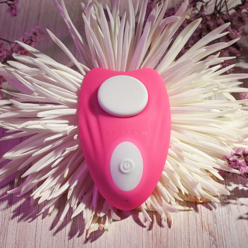 Gender X UNDER THE RADAR -  USB Rechargeable Panty Vibe on a floral background, showcasing its sleek design and controls.
