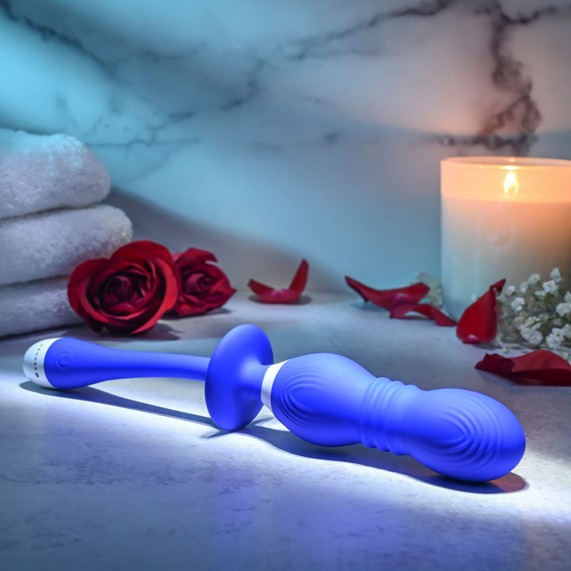 Gender X rechargeable vibrating orbs against a serene backdrop of roses, candles, and soft towels.