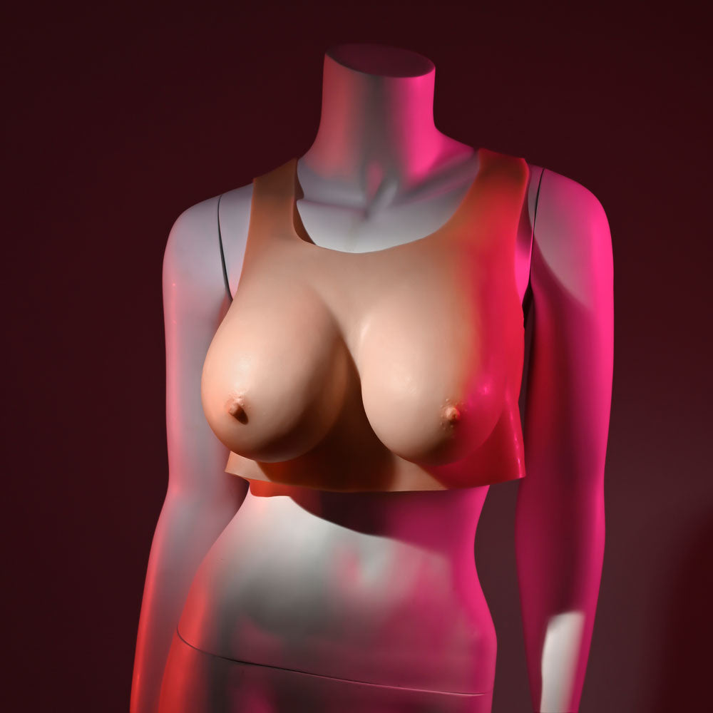 Gender X UNDERGARMENTS wearable D-cup breasts displayed on a mannequin under pink light.