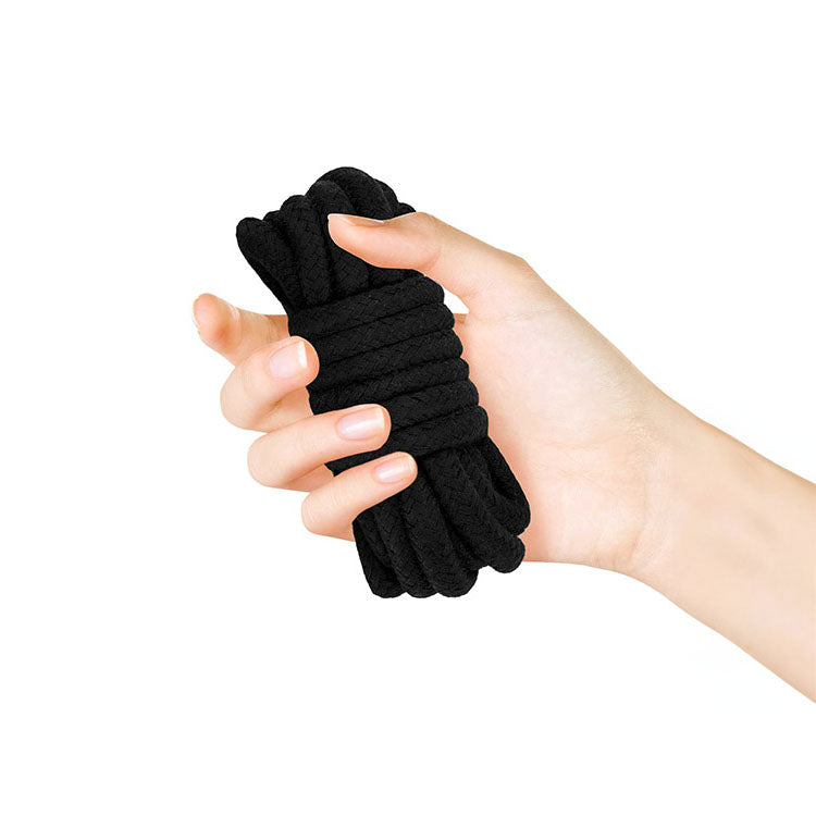 Soft bondage rope being held in hand, ideal for various bondage play and restraint during erotic activities.